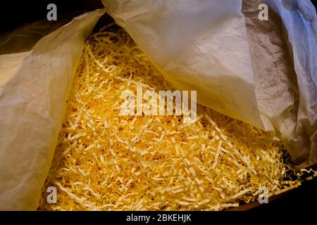Opened recycled taped cardboard posting and shipping box with shredded Paper Packing Material Delivery, mail service,shipment concept Stock Photo