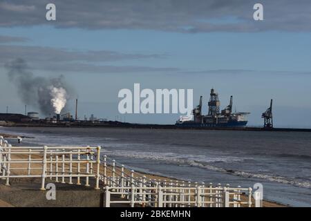 A landscape photograph of Port Talbot beach, with the steel works and the huge Sertao deep water drilling ship in the background Stock Photo