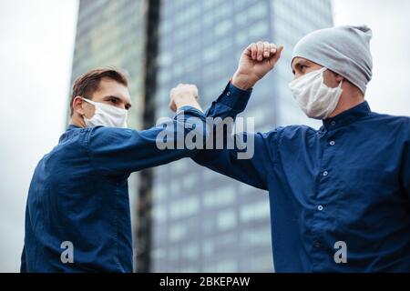 close up. two young men greeting each other with their elbows Stock Photo