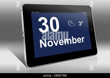 A tablet computer displays a calendar in German language with the date November 30th | Ein Tablet-Computer zeigt das Datum 30. November Stock Photo