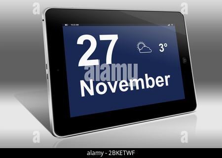 A tablet computer displays a calendar in German language with the date November 27th | Ein Tablet-Computer zeigt das Datum 27. November Stock Photo
