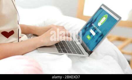 close up hand of woman ask chat bot function in app on laptop screen looking for customer support online shopping shop with apps,digital marketing con Stock Photo