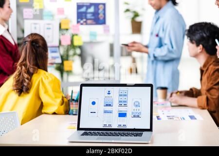 ux developer and ui designer presenting  and testing mobile app interface design on whiteboard in meeting at modern office.Creative digital developmen Stock Photo