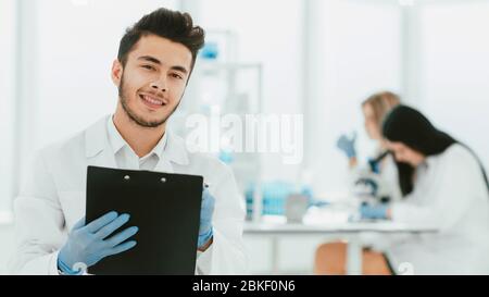 close up. a scientist doing writes the results of an experiment to a laboratory journal . photo with copy space Stock Photo