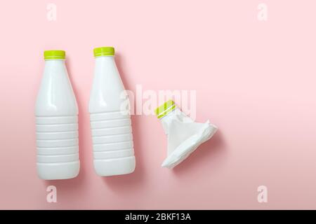 white plastic bottles on a pink background. the problem of waste disposal and recycling. Stock Photo