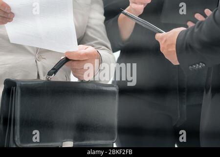 businesswoman discussing with colleagues and working papers Stock Photo