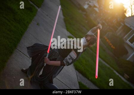 Chicago, Illinois, USA. 3rd May, 2020. ALICJA JANUSZKO, 25, of Des Plaines, Illinois, cosplaying as Rey from Star Wars and performing a dual blade kata. This was Alicja's first cosplay since May 2018, at Anime Central (ACEN), and due to unforeseen circumstances could not attend last year's. Credit: Chris Riha/ZUMA Wire/Alamy Live News Stock Photo