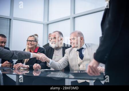 close up. business partners shaking hands at the negotiating table. Stock Photo