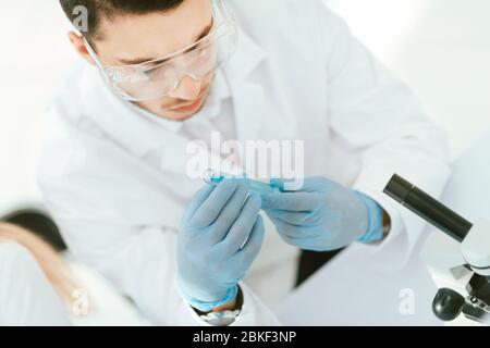 Confident young male scientist holding test tube Stock Photo