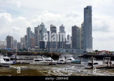 Row of pleasure boats at low tide with skyscrapers and Trump Tower in the background., Panama City, Panama Stock Photo