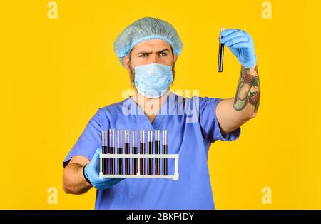 Epidemic threshold. Critical number or density of susceptible hosts. Man in medical lab inspecting samples biological material. Epidemic disease. Virus concept. Epidemic infection. Genetic analysis. Stock Photo