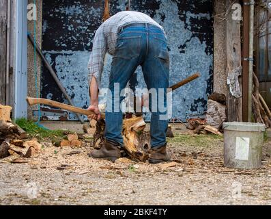 Man splitting wood Stock Photo