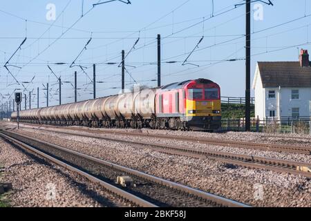 DB cargo rail UK class 60 locomotive on the 4 track east coast mainline with a long train of empty 102t bogie oil tanks Stock Photo