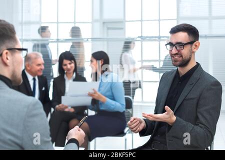 business man discussing something sitting near the office Desk Stock Photo