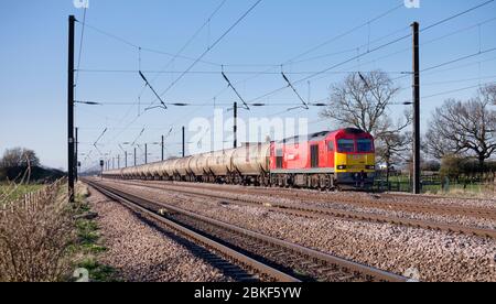 DB cargo rail UK class 60 locomotive on the 4 track east coast mainline with a long train of empty 102t bogie oil tanks Stock Photo