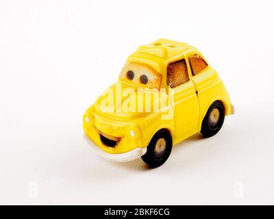 Smiling Volkswagen beetle miniature toy car Pixar Cars McDonald's Happy Meal Luigi miniature Plastic Car Stock Photo