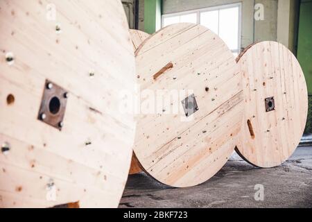 Production of wooden bobbins for winding and transporting cable electrical wires. Stock Photo