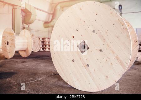 Production of wooden bobbins for winding and transporting cable electrical wires. Stock Photo