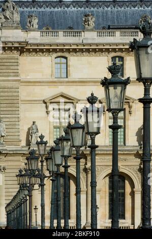 Row of lamps, Architectural details and statues on the Louvre Museum,Paris, France Stock Photo