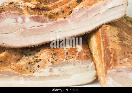 Assorted meat products, sausages, chorizo, spices on a dark table. View from above. Large selection of different dried spicy seasoned beef and pork sa Stock Photo