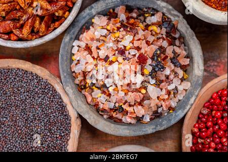 Indian spices collection, sea and rock salt mixed with red hot chili peppers and another spices in clay bowls close up Stock Photo