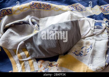 white and white and grey facemask on patterned scarf Stock Photo