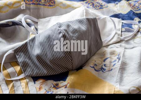 white and white and grey facemask on patterned scarf Stock Photo