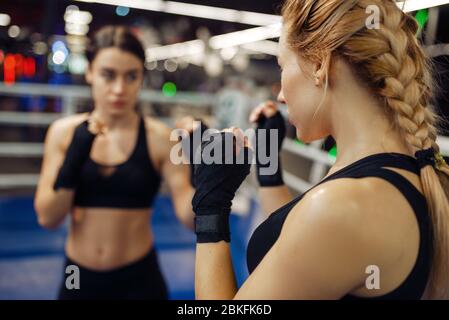 Women in boxing bandages on the ring, box training Stock Photo