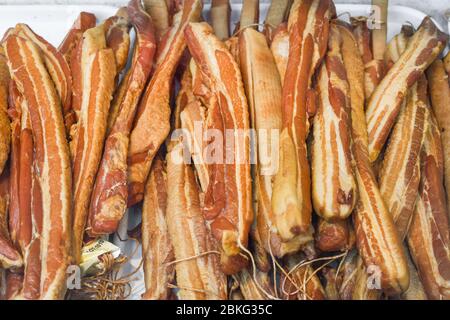 Assorted meat products, sausages, chorizo, spices on a dark table. View from above. Large selection of different dried spicy seasoned beef and pork sa Stock Photo