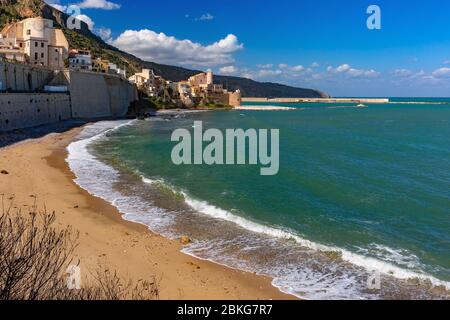 Sunny medieval fortress in Cala Marina, harbor in coastal city Castellammare del Golfo and empty Cala Petrolo Beach, Sicily, Italy