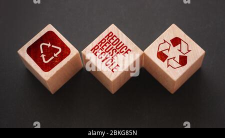 Reduce, reuse and recycle word written on wooden blocks on black. Save the planet Ecological concept Stock Photo