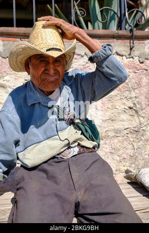 Portrait of an old peasant with a straw hat in the town of Santiago Matatlan. Stock Photo