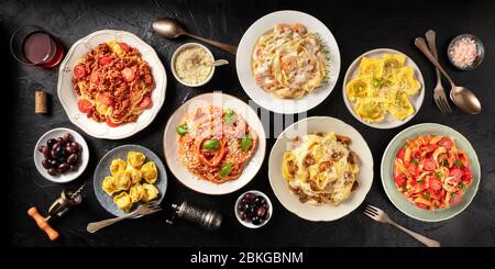 Pasta. Assortment of Italian pasta dishes, including spaghetti Bolognese, penne with chicken, tortellini, ravioli and others, shot from the top Stock Photo