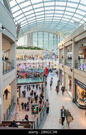 Inside view of a busy Trinity Centre in Leeds with Christmas decorations Stock Photo