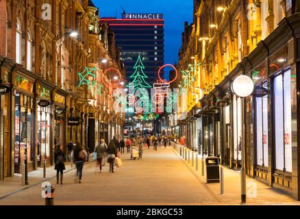 Christmas decorations and shoppers on King Edward Street in the centre of the city of Leeds, West Yorkshire Stock Photo