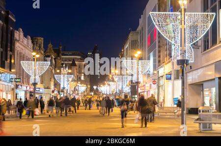 Christmas decorations and shoppers on Briggate in the centre of Leeds, West Yorkshire Stock Photo