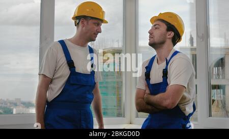 Construction workers having a talk. Stock Photo