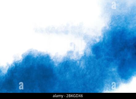 Bizarre forms of blue powder explosion cloud on white background. Launched blue dust particles splashing. Stock Photo