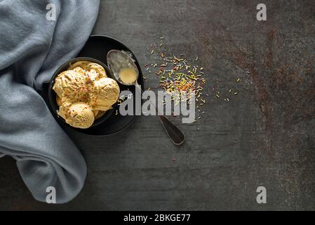 Homemade Organic Vanilla soft Ice Cream decorated with colorful sprinkles Stock Photo