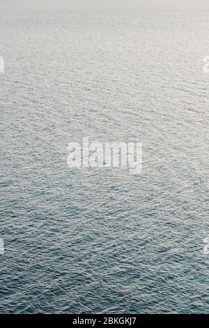 Surface of the deep blue sea in sunset light Stock Photo