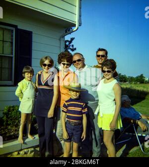1960s SMILING FAMILY FATHER MOTHER DAUGHTER SON SITTING IN CAR IN FRONT ...
