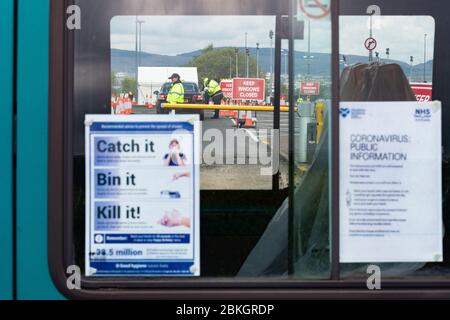 Glasgow, Scotland, UK. 4th May, 2020. Coronavirus testing at Glasgow Airport in the long stay carpark continues at a steady pace with no evidence of queuing at lunchtime today. Testing site seen through the windows of a bus being used by the NHS temporarily parked at the entrance Credit: Kay Roxby/Alamy Live News Stock Photo