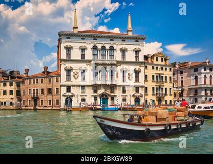 Venice, Venice Province, Veneto, Italy.  Boat transporting goods on the Grand Canal. Stock Photo