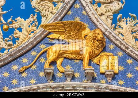 Venice, Venice Province, Veneto Region, Italy.   The winged lion above the entrance to St. Mark's basilica.  The lion is the symbol of Venice.  Venice Stock Photo