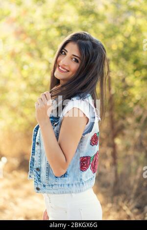 Beautiful young woman smiling outdoors Stock Photo