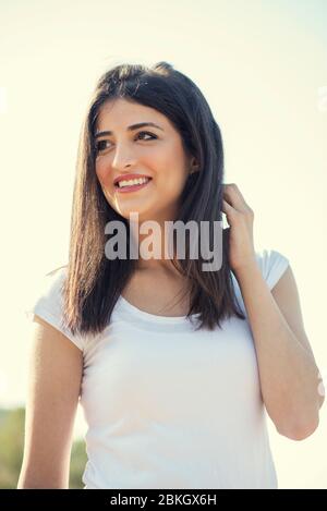 Beautiful young woman smiling outdoors Stock Photo