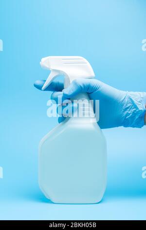 Hand in glove holds disinfectant spray Stock Photo