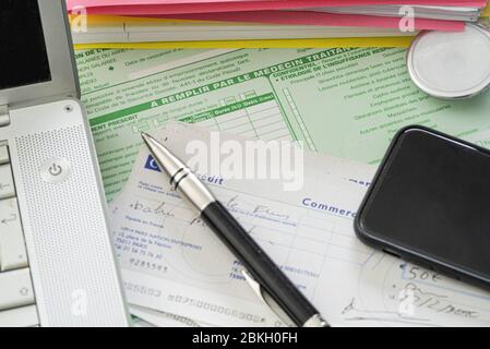 Pen, laptop, smartphone and stethoscope on medical documents Stock Photo