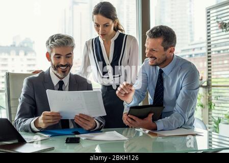 Smiling business people working in office Stock Photo