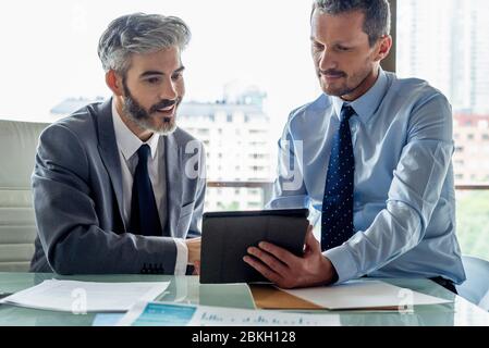 Businessmen looking at digital tablet Stock Photo